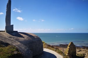 Walking path along the edge of Pointe du Hoc with sea in the background