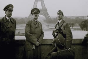 Black-and-white image of uniformed wartime figures with the Eiffel Tower behind them