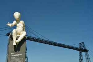 White sculpture on pedestal with the Rochefort Transporter Bridge in the background
