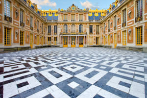 Golden gates and main façade of the Palace of Versailles