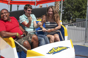 2 passengers enjoying the Tilt a Whirl ride