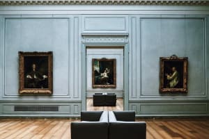 Framed paintings displayed in a National Gallery of Art exhibition room