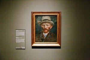 Framed Van Gogh self-portrait displayed in a museum gallery
