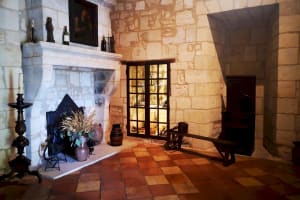 Vaulted limestone cellar with fireplace at Couvent des Jacobins Saint-Émilion winery