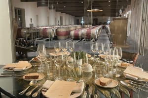 Elegant private dining table set for gastronomic lunch overlooking barrel cellar at Château Durfort-Vivens