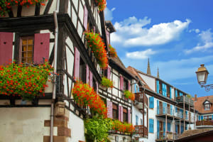 Traditional half‑timbered houses with colorful shutters and flowers in Obernai