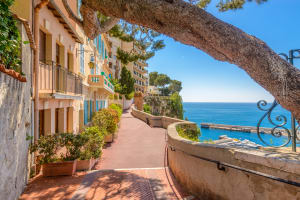 Sunlit promenade in Monaco overlooking the Mediterranean Sea