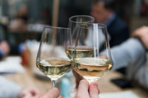 Guests raising glasses of white wine during a Loire Valley wine tasting experience.