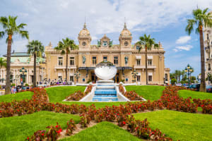 Ornate façade of the Casino de Monte-Carlo overlooking landscaped gardens in Monaco.