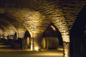 Oak wine barrels in a vaulted stone cellar in Beaune, Burgundy, France