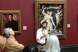 Guide speaking with visitors inside London’s National Gallery
