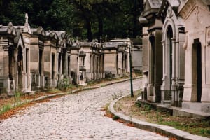 Cobblestone path lined with mausoleums at Père Lachaise