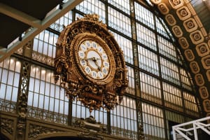 Ornate clock beneath the glass roof of Musée d’Orsay