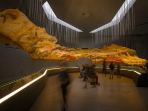 Visitors exploring prehistoric art exhibitions at Lascaux IV