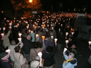  Thousands of pilgrims carrying candles and torches in the famous evening Marian procession through the Lourdes sanctuary esplanade