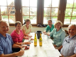 Glasses of white Alsace wine on a wooden tasting table