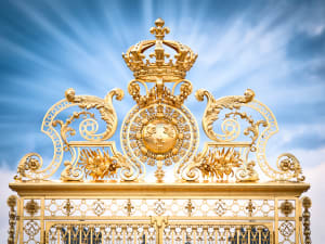 Ornate golden gate at the Palace of Versailles