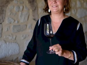 Female member of Pradel de Lavaux family winemaker holding wine glass at Château Bellevue Saint-Émilion