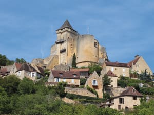 Château de Castelnaud towering above traditional stone houses in Castelnaud-la-Chapelle