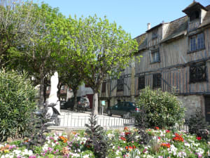 Half-timbered houses and flower-filled square in historic Bergerac, Dordogne