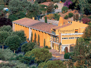 Exterior of the Fragonard perfume factory surrounded by Mediterranean gardens in Èze, France.