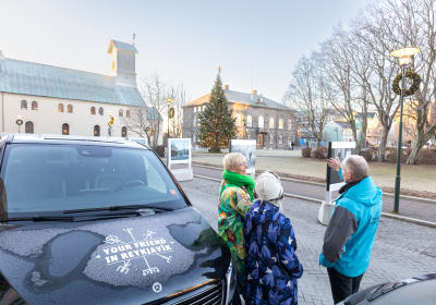 A group of travellers listening to a story shared by the Guide from Your Friend in Reykjavik 