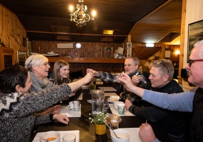 A group of Guests doing the cheers gesture