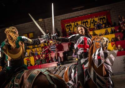 2 knights on horseback with their swords out at Medieval Times