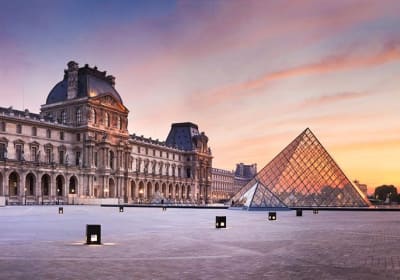 Louvre Museum and glass Pyramid at sunset
