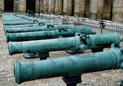 Historic cannons lined up in the courtyard of Les Invalides in Paris