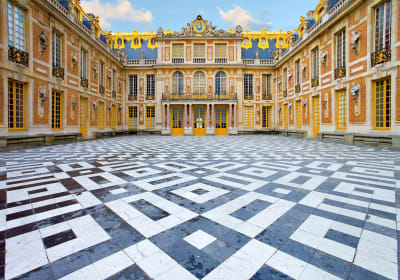 Golden gates and main façade of the Palace of Versailles