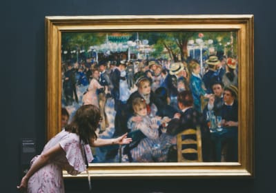 Visitor viewing Renoir’s Bal du moulin de la Galette at Musée d’Orsay