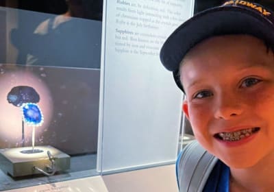 Child exploring a mineral display at the Smithsonian National Museum of Natural History