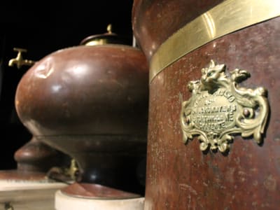 Gleaming copper alembic charentais pot stills inside a traditional Cognac distillery in the Charente region