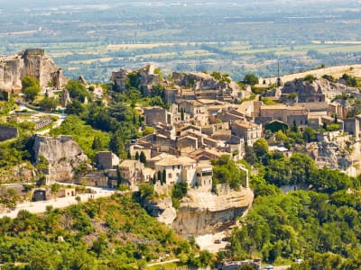 Cobbled lane in Les Baux‑de‑Provence lined with stone houses and craft shops