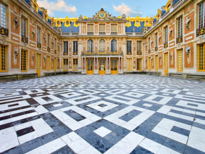 Golden gates and main façade of the Palace of Versailles