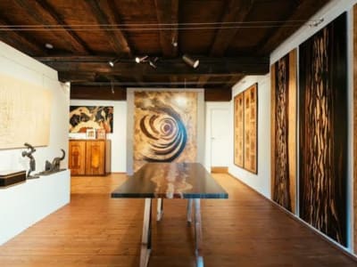 Modern marquetry panels displayed in a warm wood‑floored Spindler gallery
