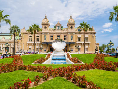 Ornate façade of the Casino de Monte-Carlo overlooking landscaped gardens in Monaco.