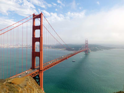 Golden Gate Bridge spanning San Francisco Bay with city skyline and Marin Headlands visible