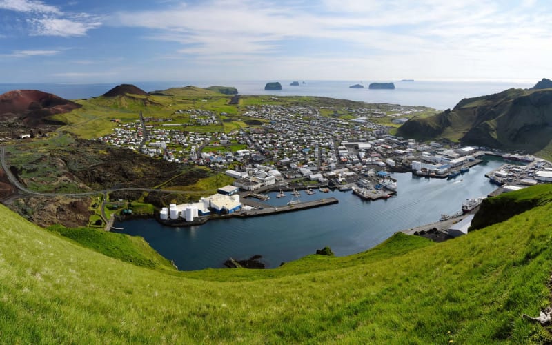 Group walking along a coastal path on Heimaey, Westman Islands
