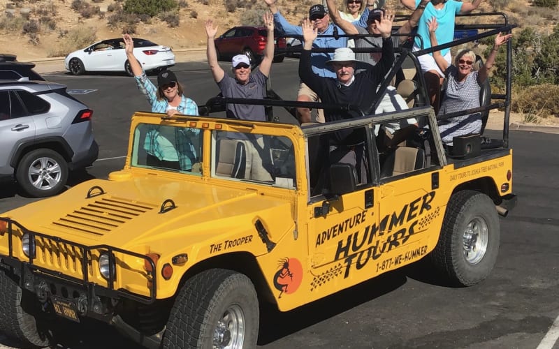 Guests enjoying an open-air Hummer Jeep-style tour from Palm Springs into Joshua Tree National Park, group adventure photo