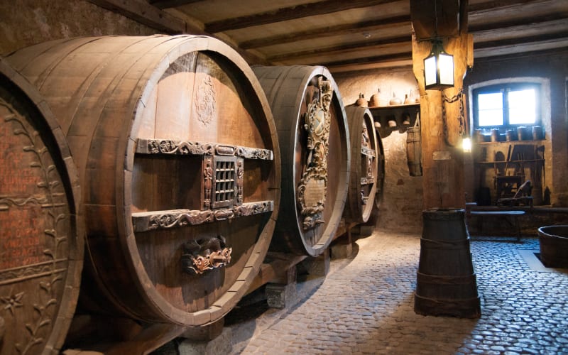 Wine barrels inside a traditional Alsace winery cellar