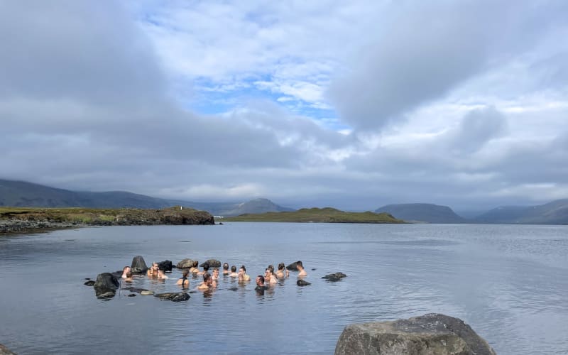 A group of travellers taking a bath in the hot springs 
