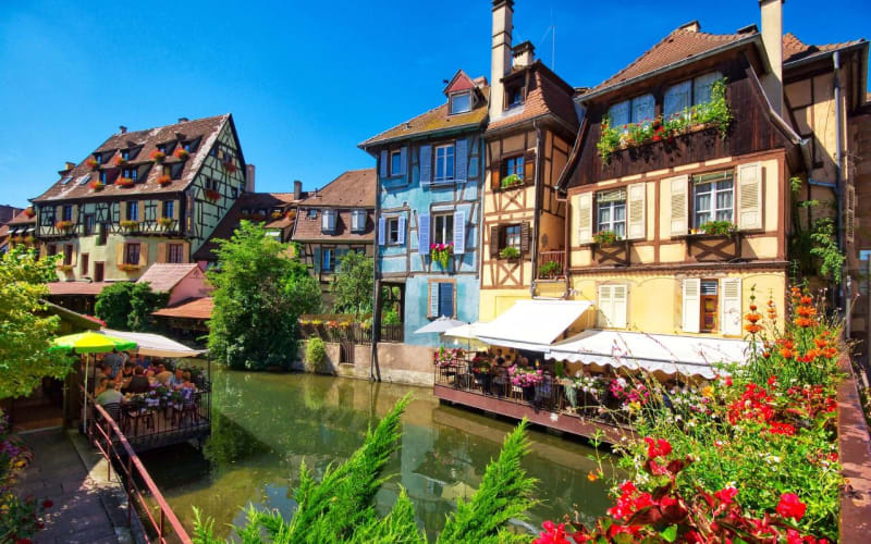 Colorful half-timbered houses reflected in the canal in Colmar’s Little Venice district