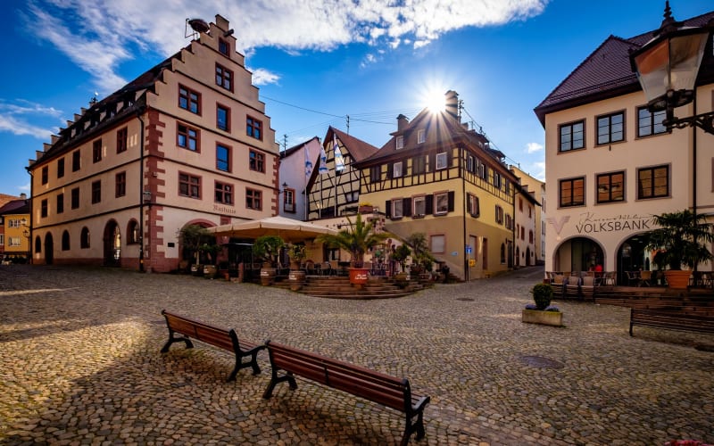 Cobbled square in Endingen with historic façades and café terrace at sunset