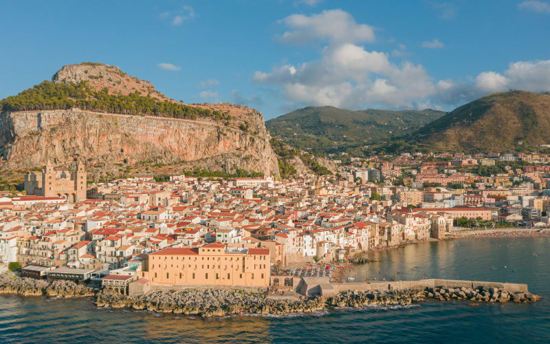 The medieval old town of Cefalù with its Norman cathedral, the harbour and La Rocca cliff behind