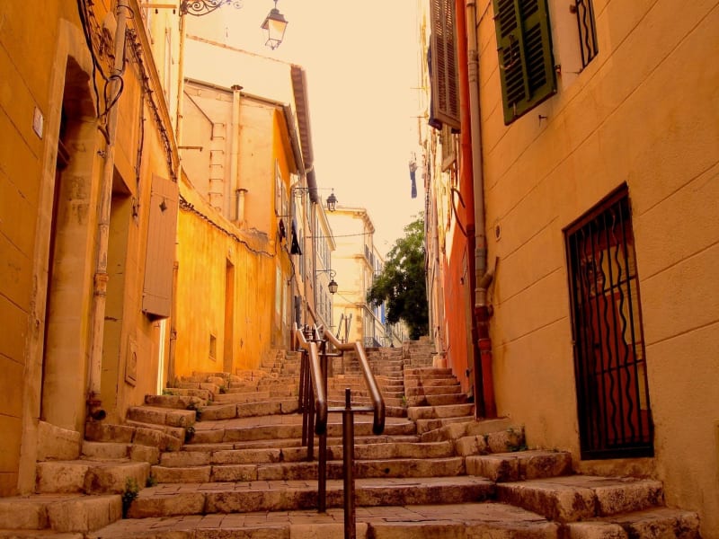 Stone staircase between colorful townhouses in Marseille’s Le Panier district