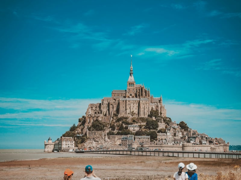 Pedestrian bridge and shuttle buses approaching Mont Saint Michel
