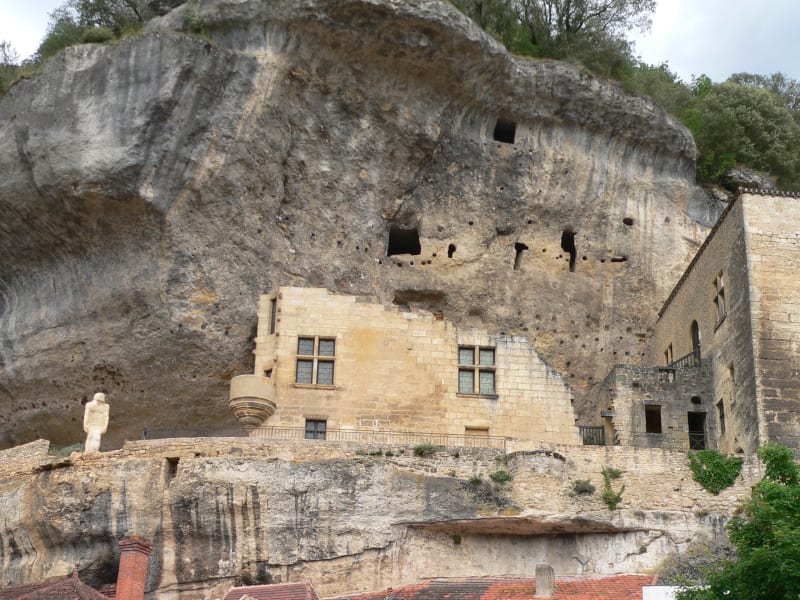 Stone museum building in Les Eyzies-de-Tayac set against a rocky cliff, in the heart of the Dordogne prehistoric valley