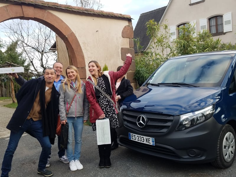 Private Mercedes minivan parked in a vineyard with guests preparing for a wine tour